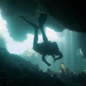 A diver passes through the caverns at "Dolphins Den" in Polly Tilly.